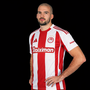 Marko Sedlaček con la maglia dell'Olympiakos Piraeus (foto con AI)
